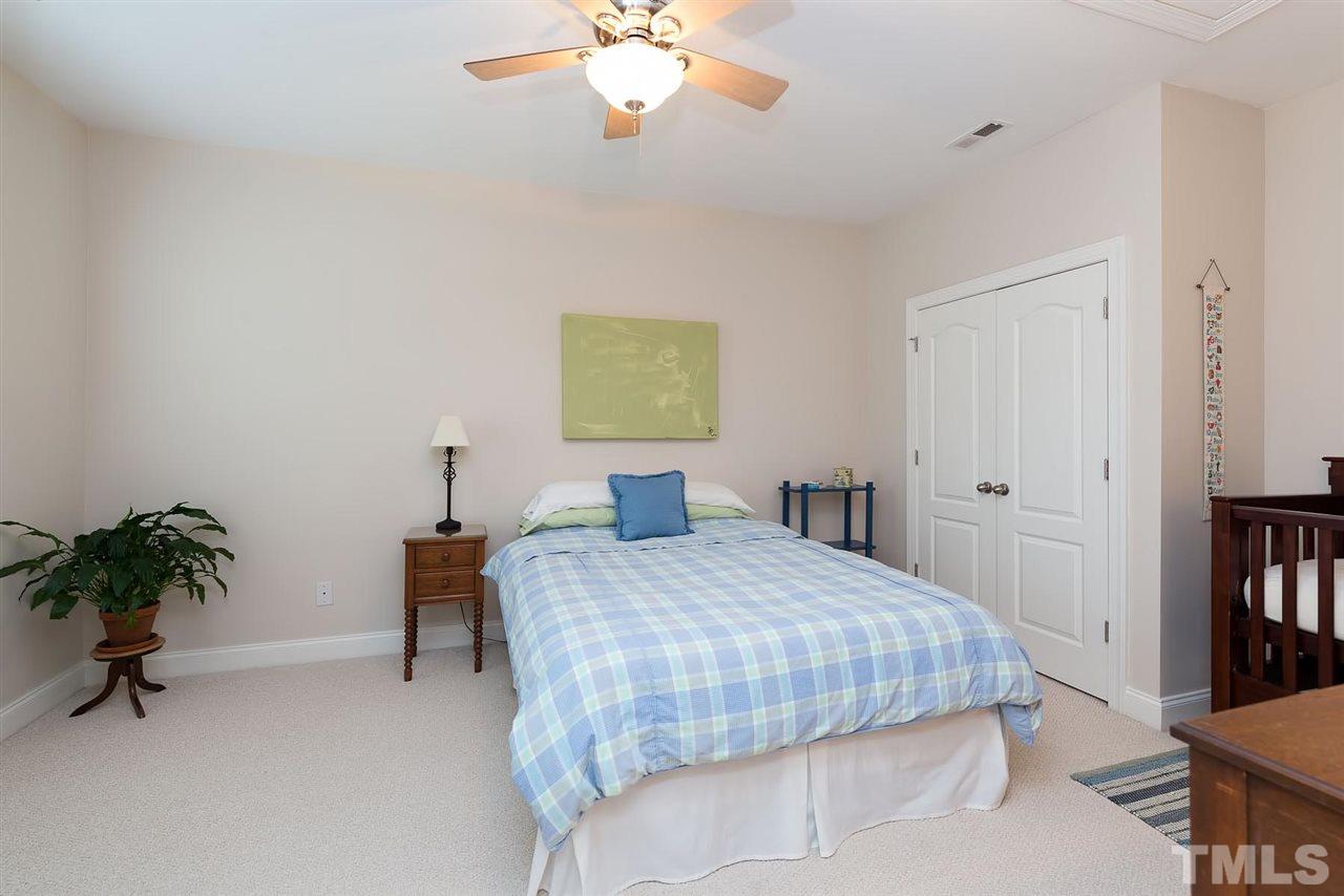 650 Democracy Street Raleigh, NC 27603 - Photo 22 of 25 a bedroom with a bed and a chandelier