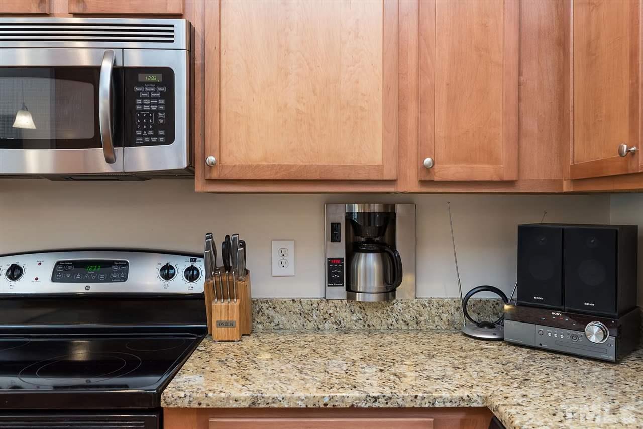 650 Democracy Street Raleigh, NC 27603 - Photo 10 of 25 a kitchen with a stove a microwave and cabinets