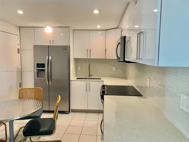a kitchen with a refrigerator and a sink