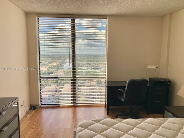a view of a livingroom with furniture and a window