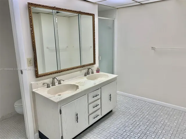 a bathroom with a double vanity sink and a mirror