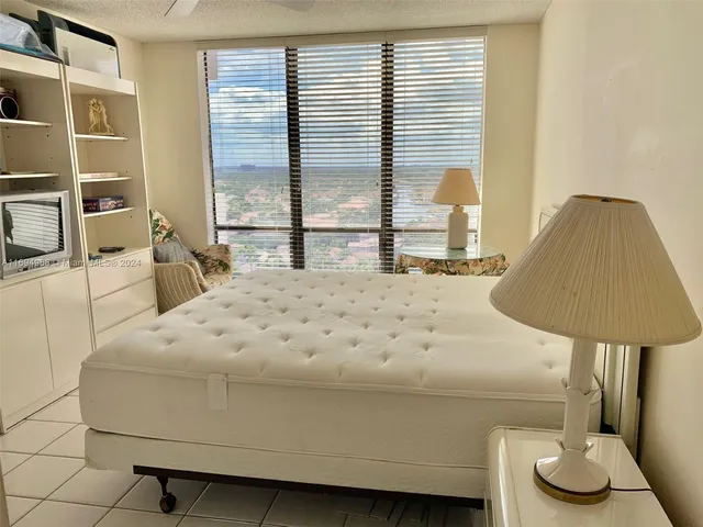 a bedroom with a bed and a lamp