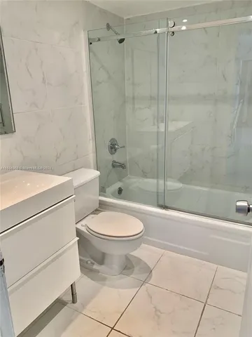 a bathroom with a toilet a sink and a shower