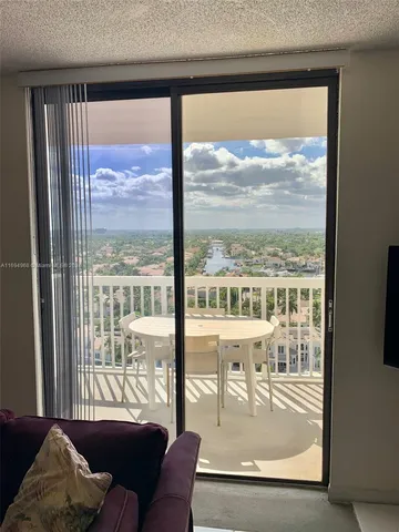 a view of a room with a large window and a couch