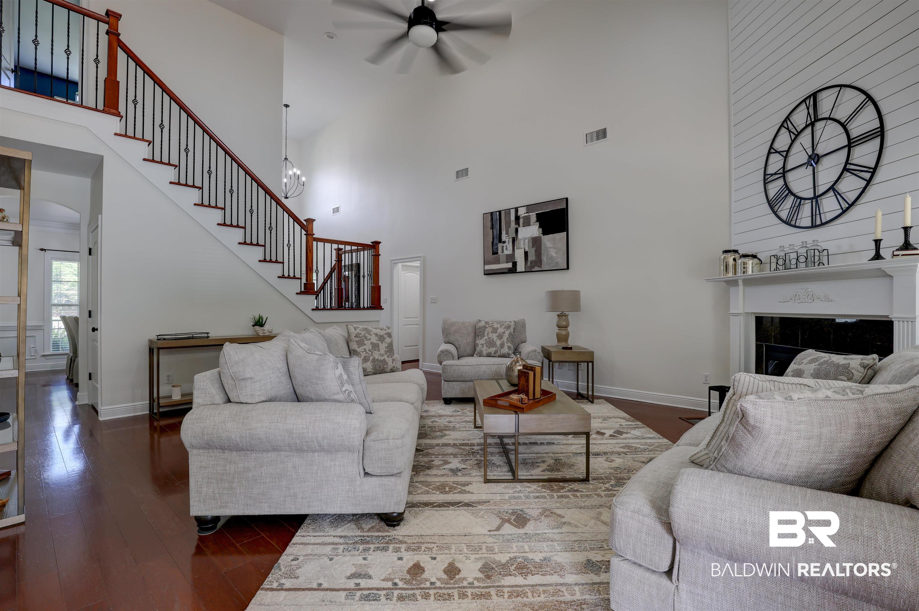 5565 Dawes Lane Theodore, AL 36582 - Photo 5 of 38 Living room with a high ceiling, ceiling fan, a fireplace, and dark hardwood / wood-style floors