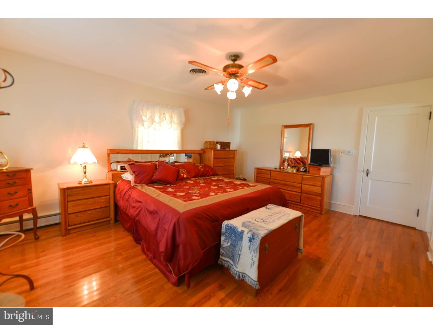 742 Salem Quinton Road Quinton, NJ 08079 - Photo 3 of 23 a bed room with a bed mirror and a lamp
