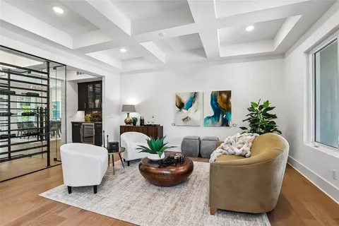 a living room with furniture a lamp and a chandelier