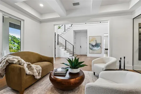 a living room with furniture ceiling fan and a large window