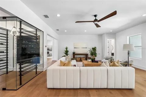 a kitchen with stainless steel appliances a dining table chairs and wooden floor
