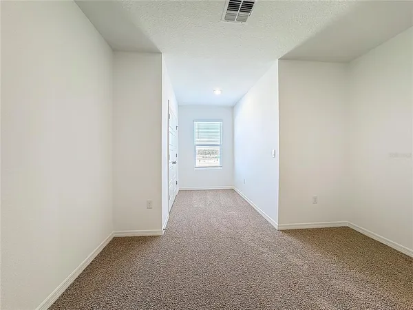 an empty room with a empty space and windows