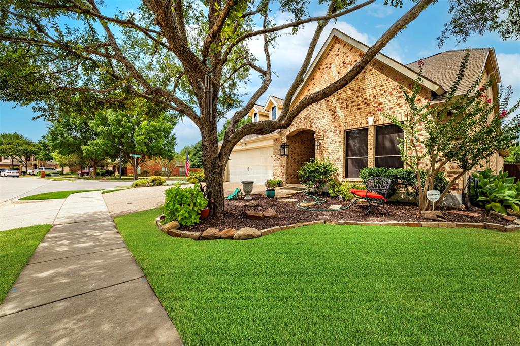 1601 Meadow Ranch Road McKinney, TX 75071 - Photo 31 of 31 Brick exterior with arched entryway, attached garage, and a gabled roof