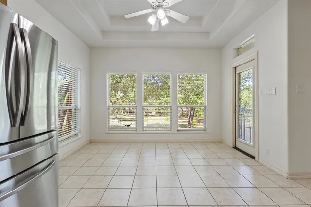 a large kitchen with a large counter top stainless steel appliances and cabinets