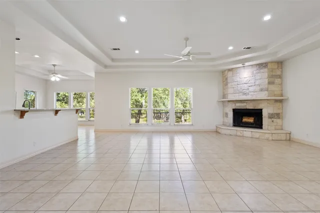 a view of a livingroom with a ceiling fan and window