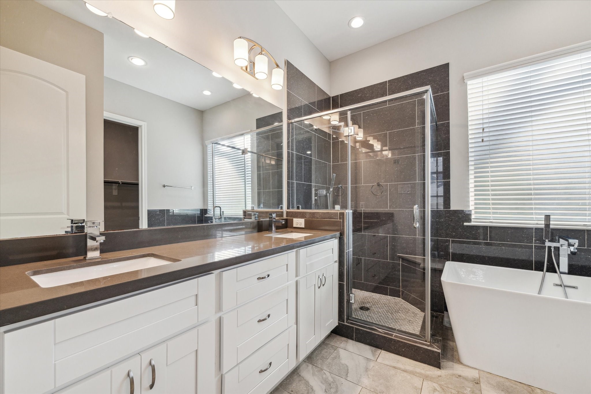 5610 Patrick Street, Unit A Houston, TX 77076 - Photo 4 of 11 a bathroom with a double vanity sink a toilet a bathtub and shower