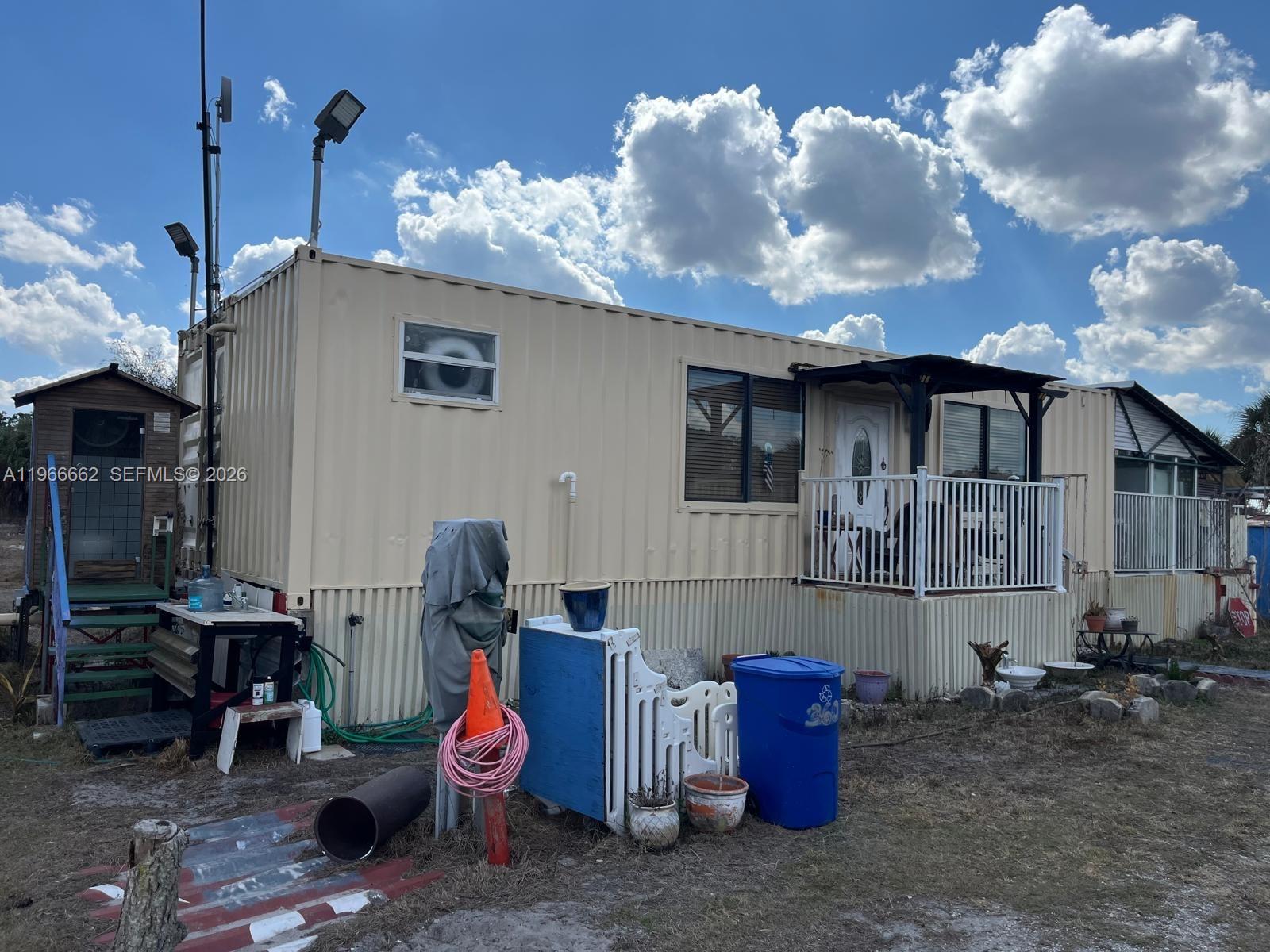 360 South Brida Street Clewiston, FL 33440 - Photo 1 of 14 a backyard of a house with barbeque oven table and chairs
