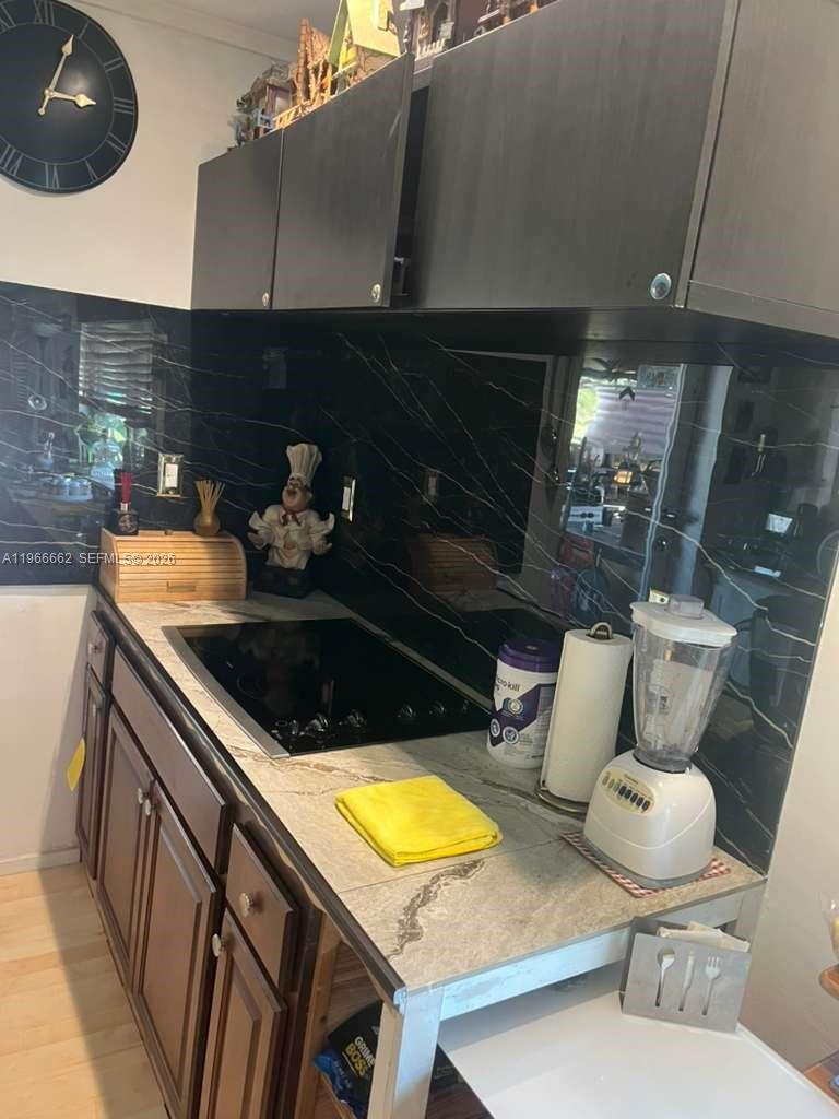 360 South Brida Street Clewiston, FL 33440 - Photo 13 of 14 a kitchen with a sink and a stove