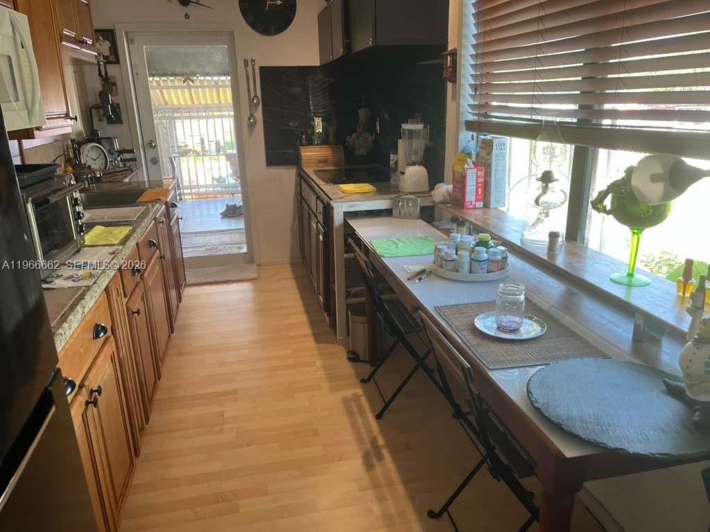 360 South Brida Street Clewiston, FL 33440 - Photo 14 of 14 a dining room with furniture and a floor to ceiling window