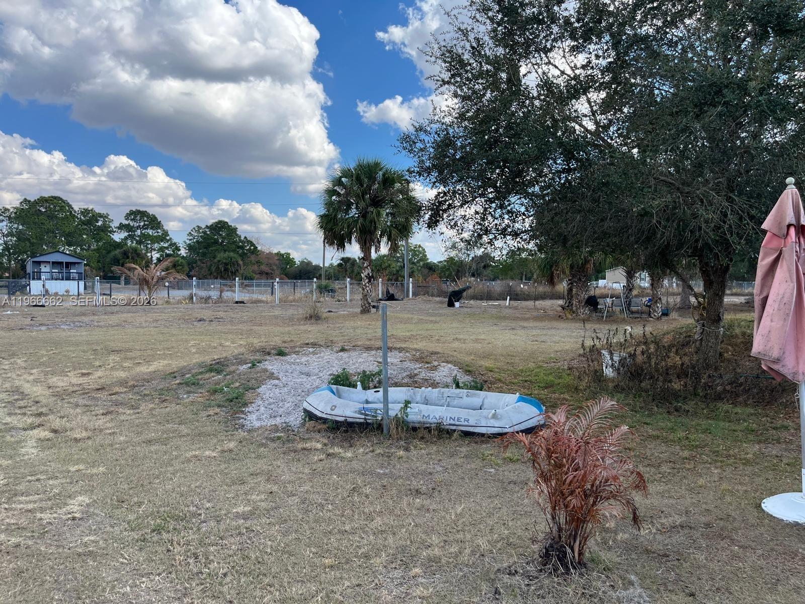 360 South Brida Street Clewiston, FL 33440 - Photo 3 of 14 a backyard of a house with table and chairs