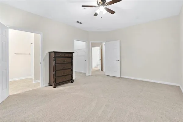 a view of an empty room with a ceiling fan