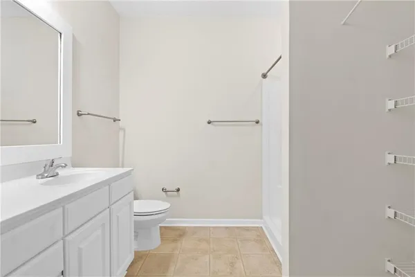 a bathroom with a sink a toilet and a shower