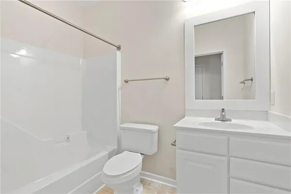 a bathroom with a toilet a sink a mirror and a shower