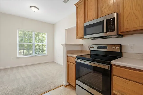 a kitchen with a stove microwave and sink