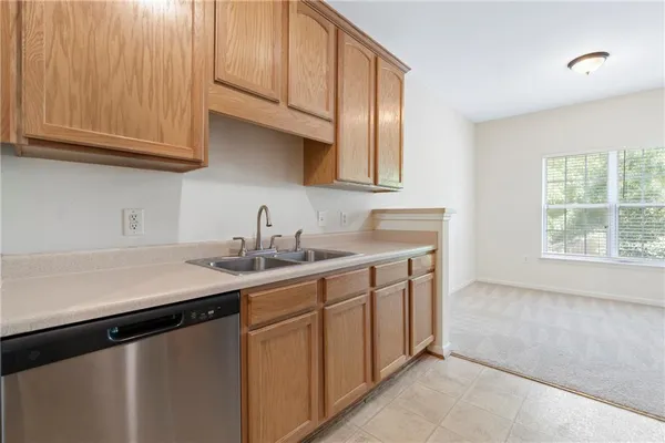 a kitchen with stainless steel appliances granite countertop a sink and a white cabinets