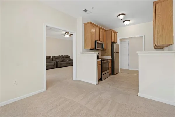 a view of kitchen and refrigerator
