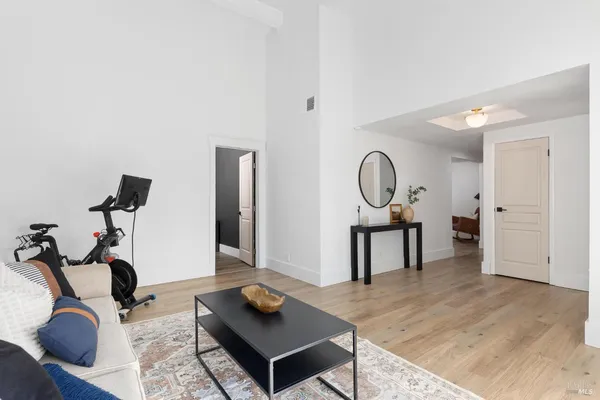 a living room with furniture a rug and a wooden floor