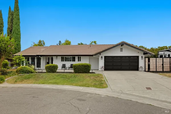 a front view of a house with yard and garage