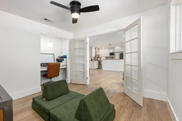 a living room with furniture and a wooden floor