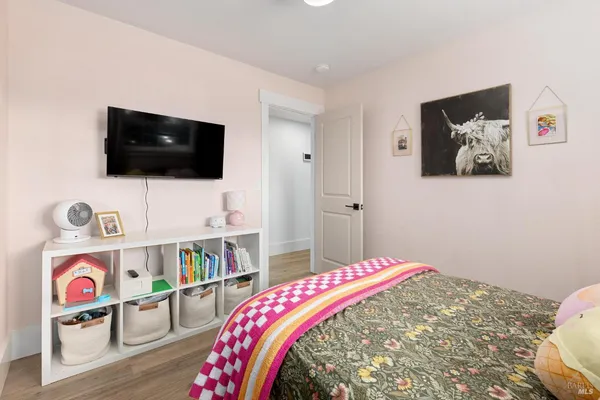 a bedroom with a bed and flat screen tv