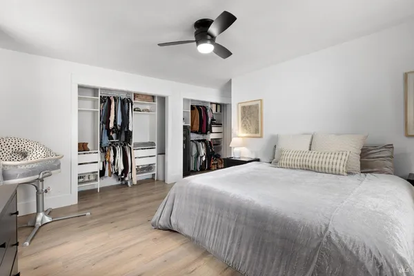 a spacious bedroom with a bed and a chandelier