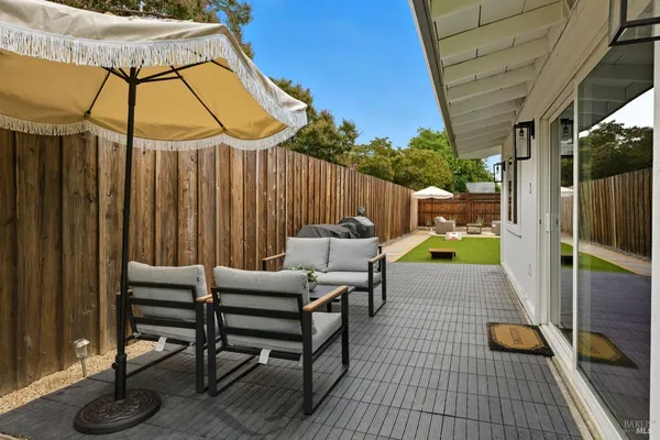 a backyard of a house with table and chairs