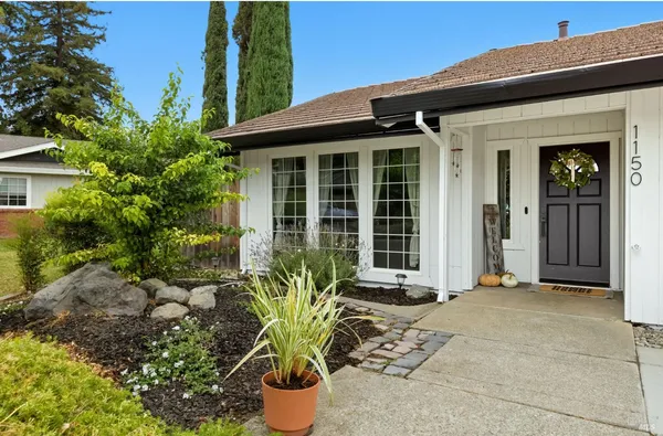 a front view of a house with a garden