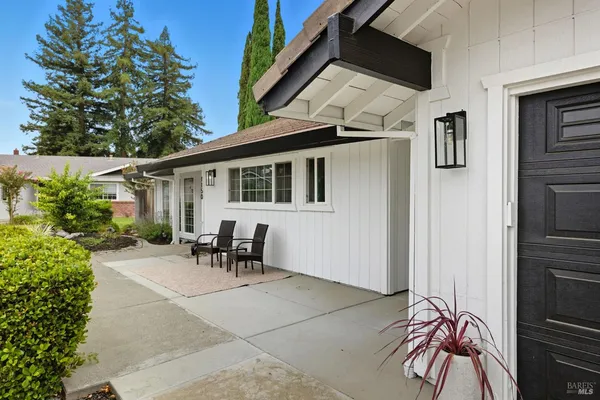 a backyard of a house with table and chairs