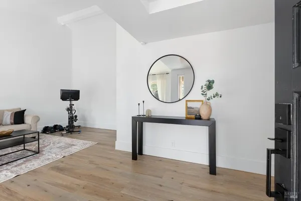 a living room with furniture a mirror and a piano