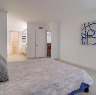 a view of an empty room with wooden floor and cabinet