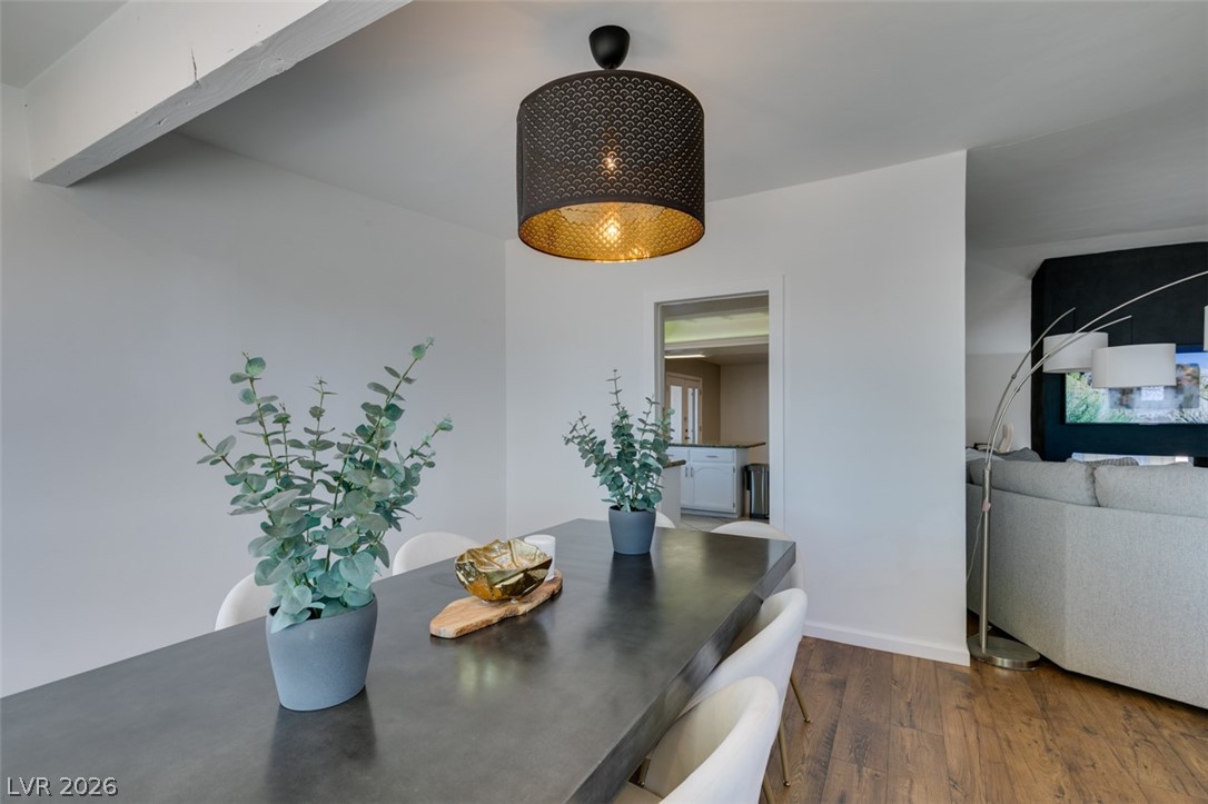 892 North Hollywood Boulevard Las Vegas, NV 89110 - Photo 9 of 81 This bright dining area features an overhead chandelier, rich wood flooring, and an open layout.