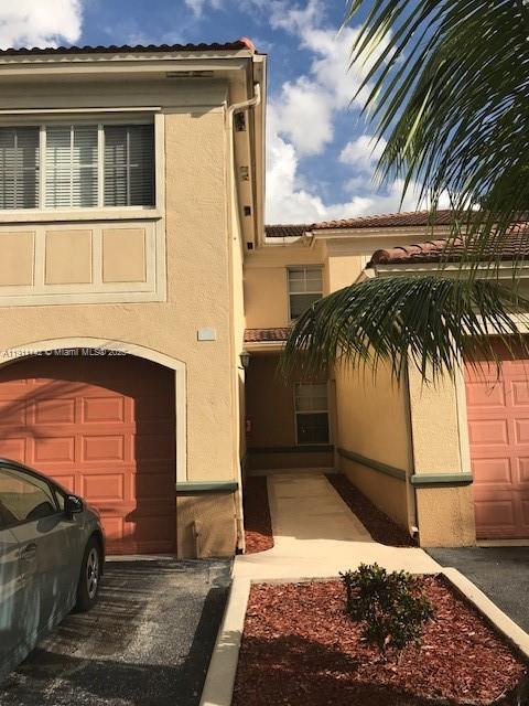 2469 Centergate Drive, Unit 203 Miramar, FL 33025 - Photo 1 of 13 a view of a house with a yard