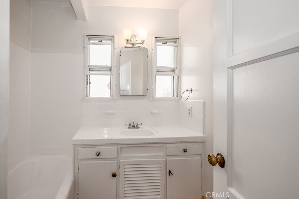 711 North Howard Street Glendale, CA 91206 - Photo 13 of 20 a bathroom with a sink and a mirror