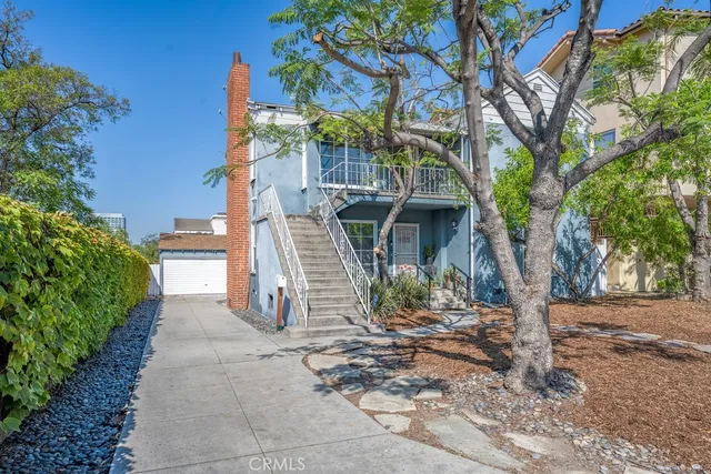 a view of a house with a tree