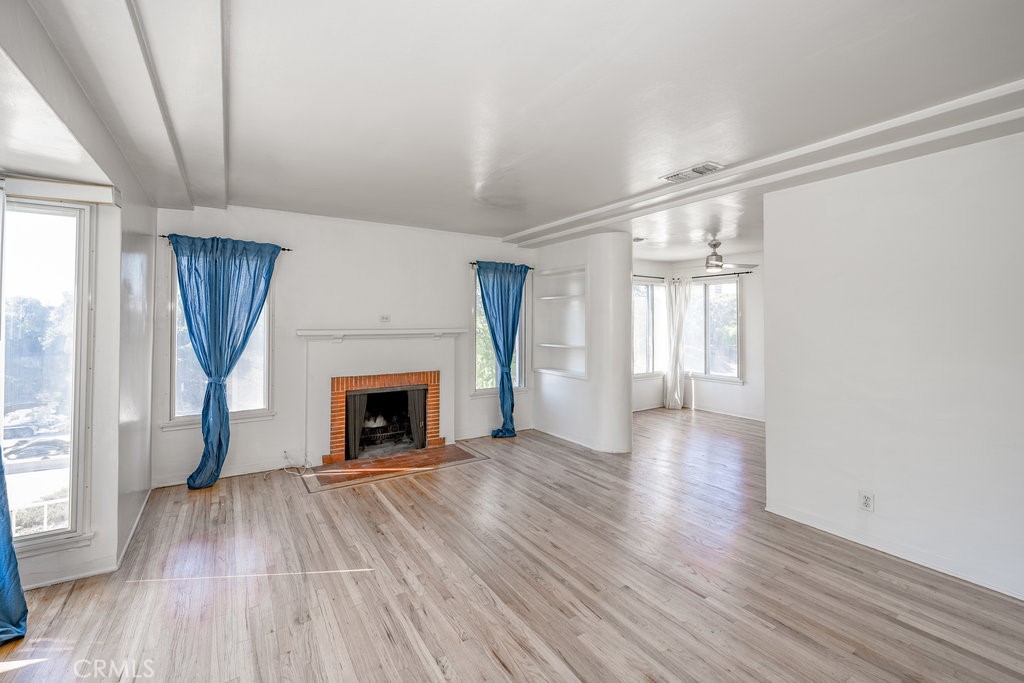 711 North Howard Street Glendale, CA 91206 - Photo 4 of 20 wooden floor fireplace and windows in an empty room