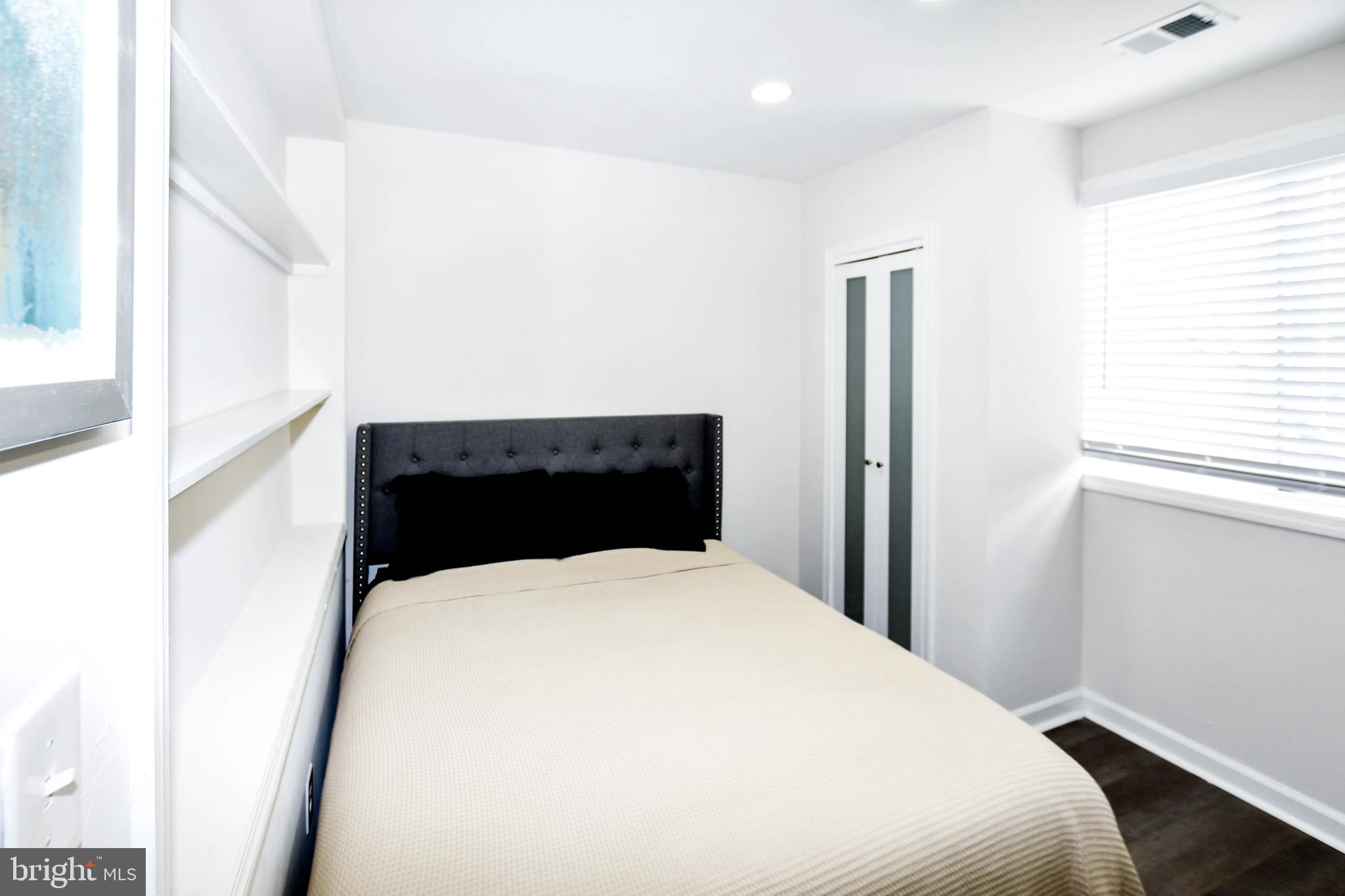 554 Newcomb Street Southeast, Unit 4 Washington, DC 20032 - Photo 14 of 34 a bedroom with a bed and a window