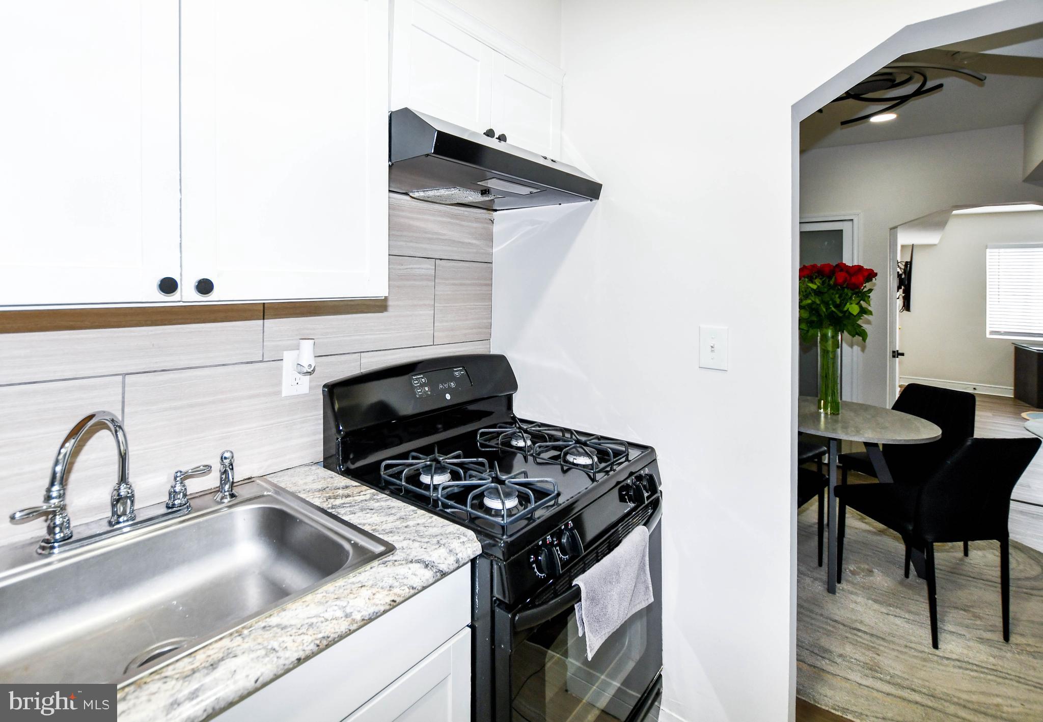 554 Newcomb Street Southeast, Unit 4 Washington, DC 20032 - Photo 16 of 34 a kitchen with a sink cabinets and appliances