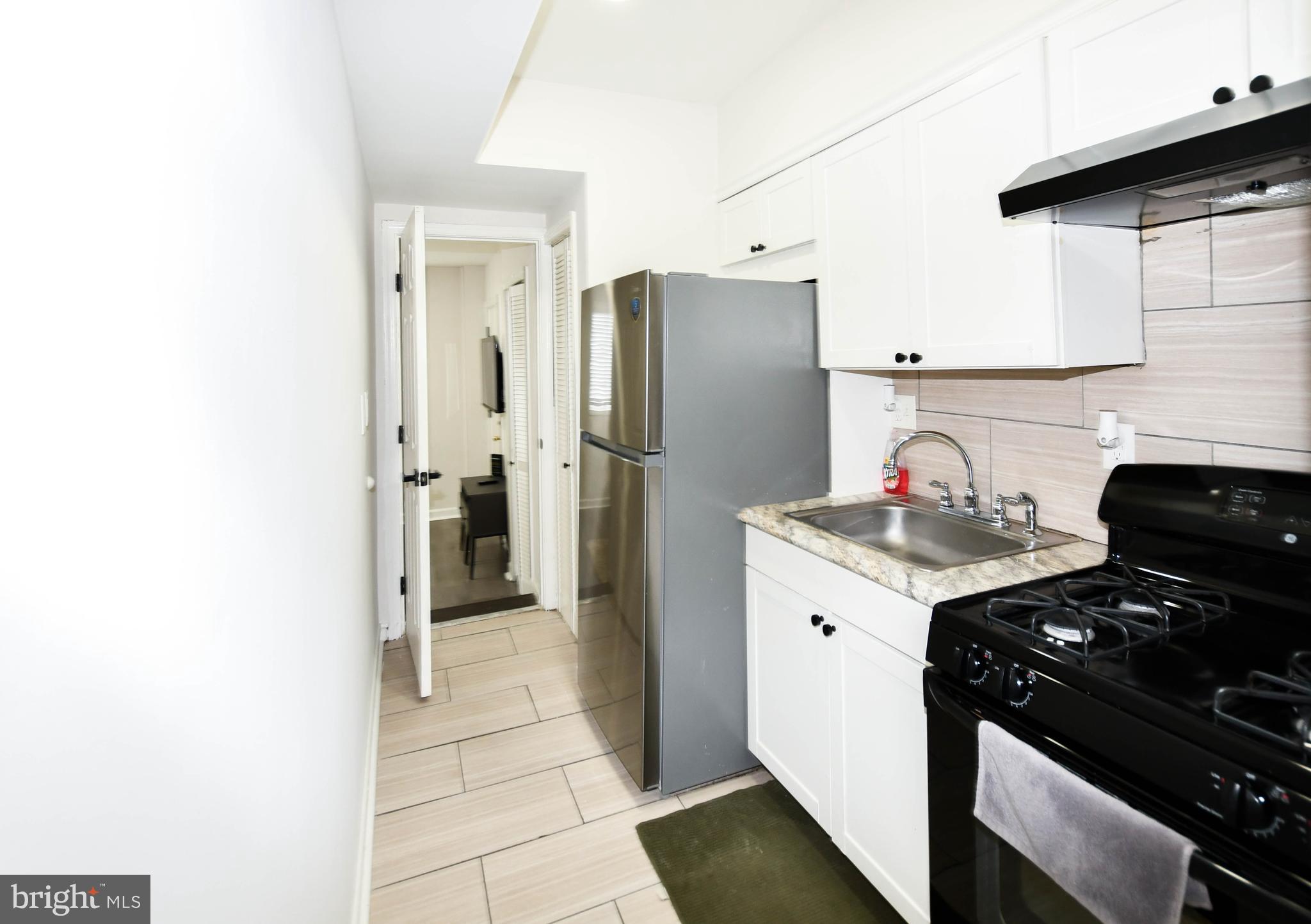 554 Newcomb Street Southeast, Unit 4 Washington, DC 20032 - Photo 17 of 34 a kitchen with a stove and a refrigerator