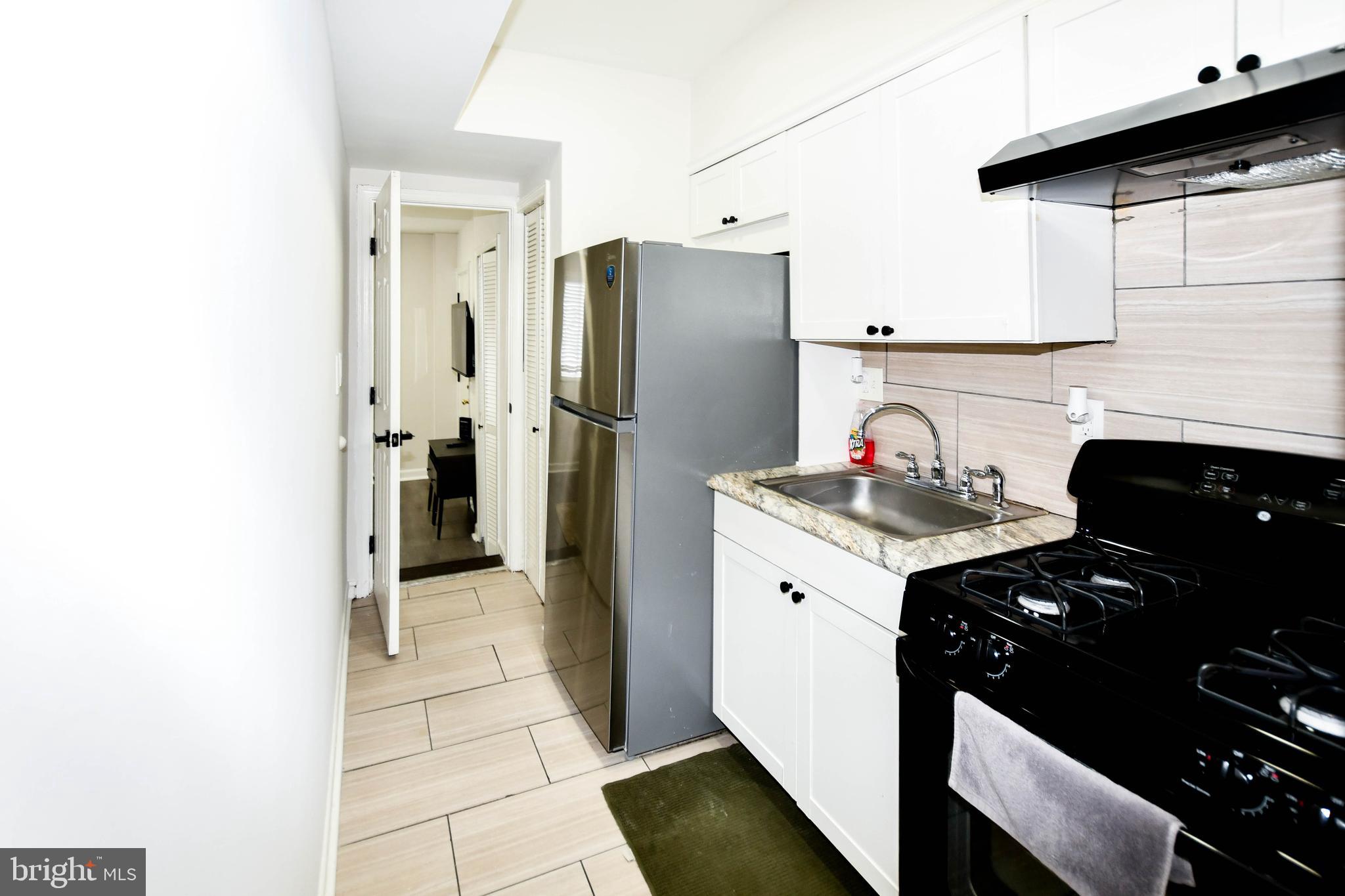 554 Newcomb Street Southeast, Unit 4 Washington, DC 20032 - Photo 18 of 34 a kitchen with a refrigerator and a stove