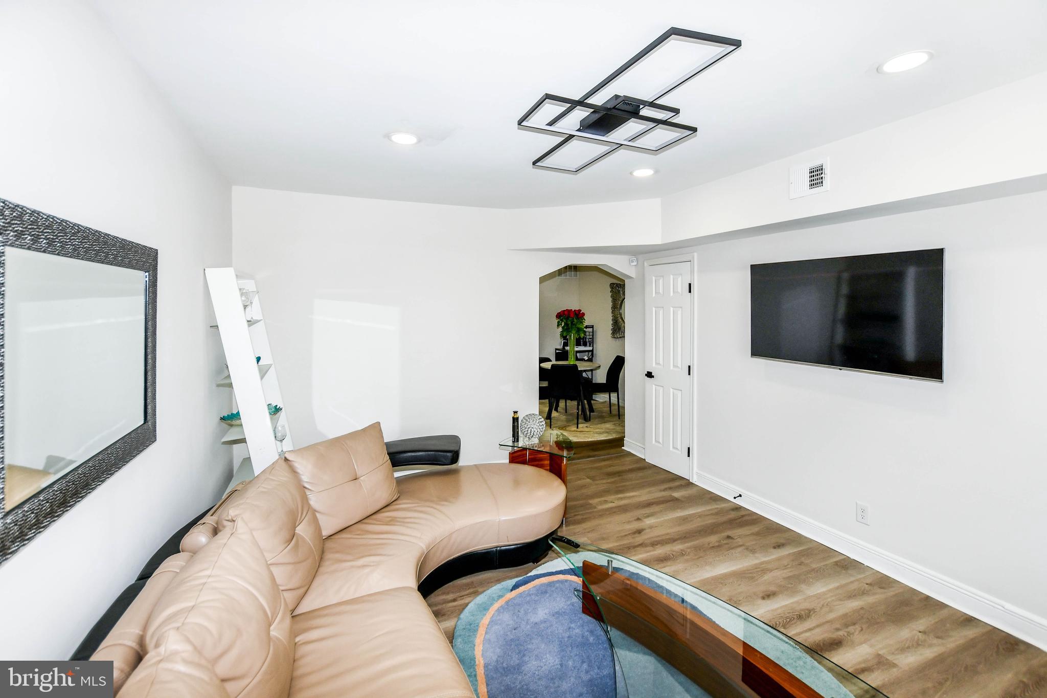 554 Newcomb Street Southeast, Unit 4 Washington, DC 20032 - Photo 28 of 34 a living room with furniture and a flat screen tv