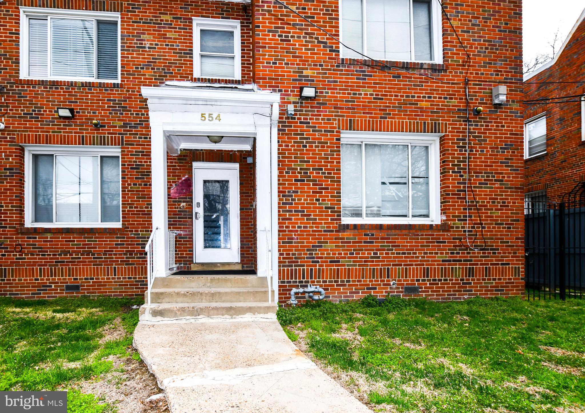 554 Newcomb Street Southeast, Unit 4 Washington, DC 20032 - Photo 3 of 34 a front view of a house with garden