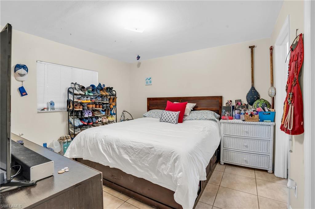 2388 55th Terrace Southwest Naples, FL 34116 - Photo 12 of 42 Bedroom with light tile floors